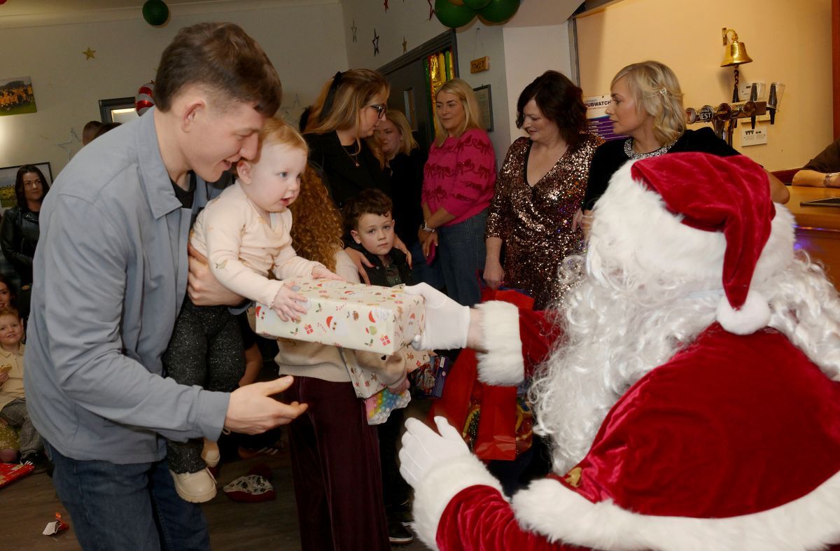 Steven Campbell, Production Operator, with one of the youngest party goers is amazed to receive a gift from SantaPhotograph: Iain Ferguson, alba.photos.